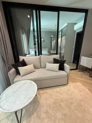 a living room with a couch and a table at Legendary D202 - The Title Legendary Bangtao Beach by UNO in Bang Tao Beach