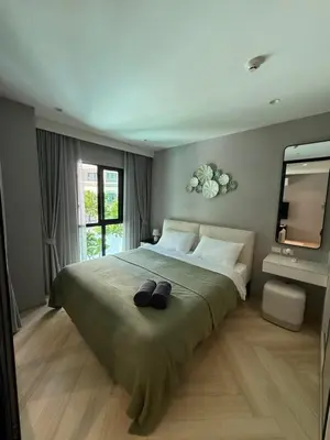 a bedroom with a large bed with two hats on it at Legendary D202 - The Title Legendary Bangtao Beach by UNO in Bang Tao Beach