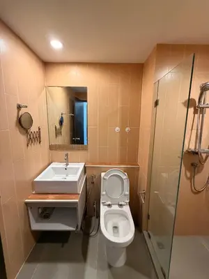 a bathroom with a toilet and a sink and a shower at MiCasa - 2BR Centrio 7th Floor in Ban Rangeng
