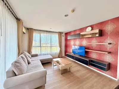 a living room with a couch and a tv at MiCasa - 2BR Centrio 7th Floor in Ban Rangeng