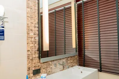 a bathroom with a mirror and a sink at Beachfront 1 Deluxe BR Luxury Pool Patong Phuket in Patong Beach