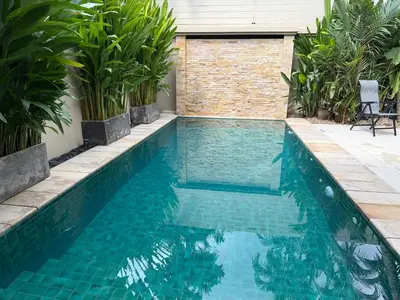 a swimming pool in a backyard with plants at Bella Home 2BR Pool Villa min to Bang Tao Beach in Ban Thalat Choeng Thale