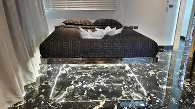 a bed with two pillows on it in a room at PATONG TOWER 5's STAR in Patong Beach