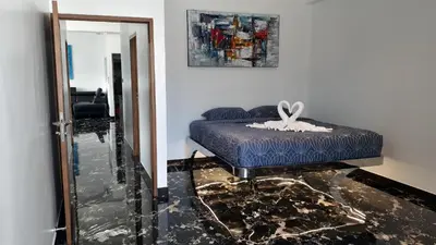 a bedroom with a blue bed and a mirror at PATONG TOWER 5's STAR in Patong Beach