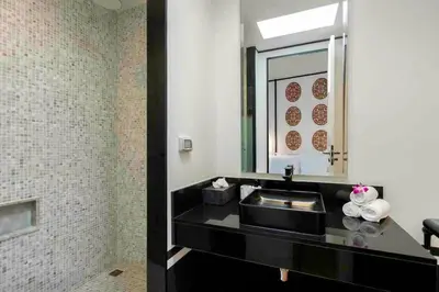 a bathroom with a black sink and a mirror at Mono Villas Pasak - Three Bedroom Pool Villa in Bangtao in Ban Pak Lak