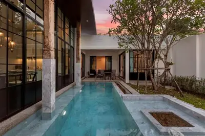 a swimming pool in the middle of a house at Mono Villas Pasak - Three Bedroom Pool Villa in Bangtao in Ban Pak Lak