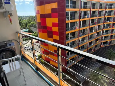 a balcony with a colorful tile wall on a building at 777 Beach Condo in Ban Mai Salae