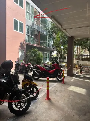 a group of motorcycles parked in a parking lot at Phuket Kata Studio Apartment in Kata Beach