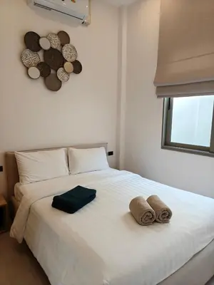 a white bed with two towels and hats on it at V-004 4 BR Unique Villa Baan Bua in Rawai Beach
