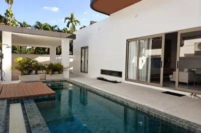 a villa with a swimming pool and a house at V-004 4 BR Unique Villa Baan Bua in Rawai Beach