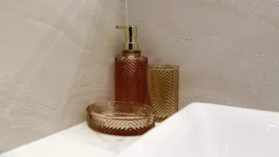 a red bottle and a basket next to a sink at Chardonnay Naiharn 1BR spacious apart BRAND new in Rawai Beach