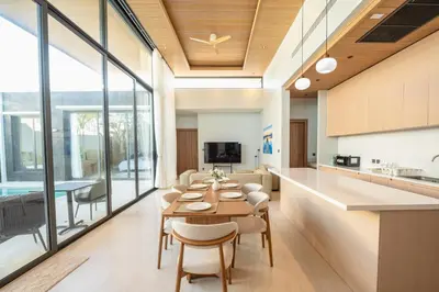 a kitchen and dining room with a table and chairs at Holiday pool villa in Ban Na Nai