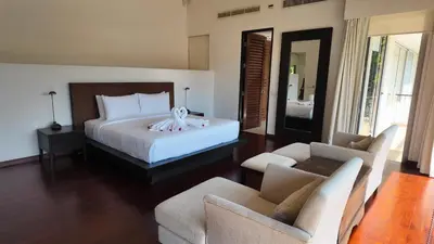 a bedroom with a bed and a living room at Villa Samakee Luxury 5 Bedroom Villa in Ban Thalat Choeng Thale