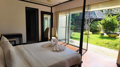 a bedroom with a bed and a large window at Villa Samakee Luxury 5 Bedroom Villa in Ban Thalat Choeng Thale