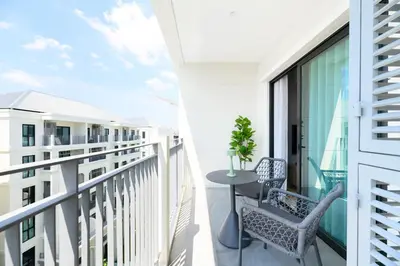a balcony with a table and chairs on a building at High-end 1BR at Title Bangtao by Sabay Rent E704 in Bang Tao Beach