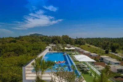 an aerial view of a resort with a swimming pool at 1 BR Balcony Pool and Garden View - Babylon Sky M206 in Rawai Beach