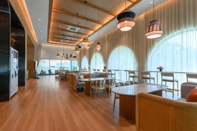 a restaurant with tables and chairs and windows at Bangtao Premium 2BR Apartment, Title Legendary B201 in Bang Tao Beach