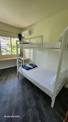 two bunk beds in a room with a window at TwinVillaSky in Ban Muang Mai