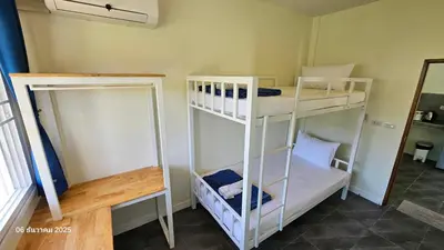 two white bunk beds in a room with a mirror at TwinVillaSky in Ban Muang Mai