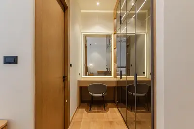 a room with a desk with two chairs and a mirror at PRAIA Residence 4BR - Bangtao in Ban Pak Lak