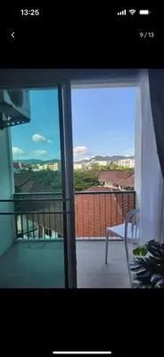 a view of a balcony with a table and a chair at Charming Condo in Wichit Comfort Meets Convenience in Ban Rangeng