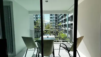 a balcony with a table and chairs on a building at Centrio 2 bed rooms 52 in Ban Lo Long