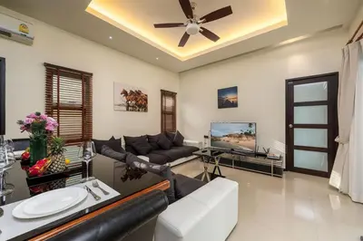 a living room with a couch and a tv at VILLA Kaheru Private Pool Near Nai Harn Beach in Nai Harn Beach