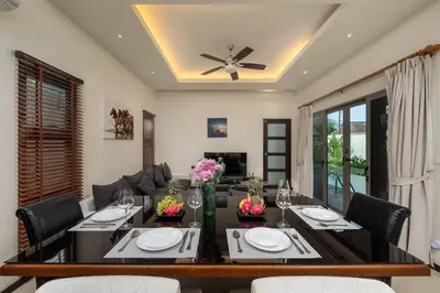 a living room with a dining room table with chairs at VILLA Kaheru Private Pool Near Nai Harn Beach in Nai Harn Beach