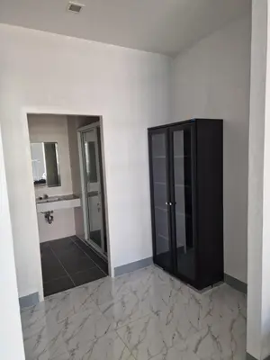 a bathroom with a black cabinet and a mirror at Eid and Philippe's Home building A9 in Ban Ko Kwang
