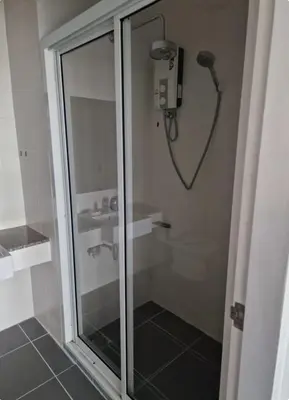 a shower with a glass door in a bathroom at Eid and Philippe's Home building A9 in Ban Ko Kwang