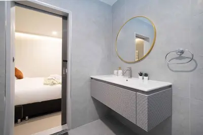 a bathroom with a sink and a mirror and a bed at Heaven pool villa reach beach in 3 mins bangla10m in Patong Beach