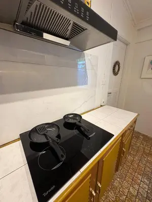 a kitchen with a black stove top in a kitchen at 3BR Family Villa - 1 km to Chalong Pier with WiFi in Chalong