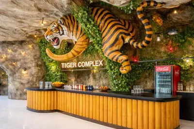 a tiger lobby with a tiger counter with a tiger on the wall at Tiger Complex Suites in Patong Beach