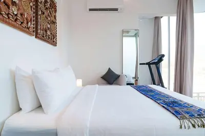 a white bed in a room with a window at Mountain View 4BR Pool Villa Minutes to Kamala in Kamala Beach