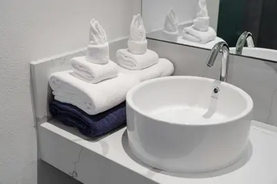 a bathroom with a sink and towels on a counter at Mountain View 4BR Pool Villa Minutes to Kamala in Kamala Beach