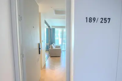 a view of a living room with a chair and a door at KORA 257 D One-Bedroom Residence in Phuket Town