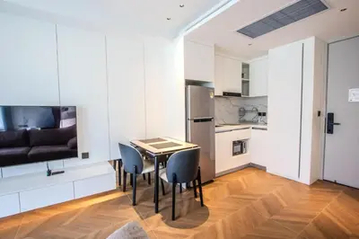 a kitchen and dining room with a table and chairs at KORA 257 D One-Bedroom Residence in Phuket Town