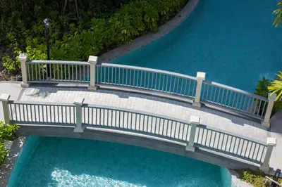 an overhead view of a bridge over a pool of water at Safi 1BR Suite — The Title Legendary BangTao in Bang Tao Beach