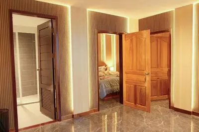 a room with a door open to a bedroom at Private Jacuzzi Pool Suite near walking street in Patong Beach