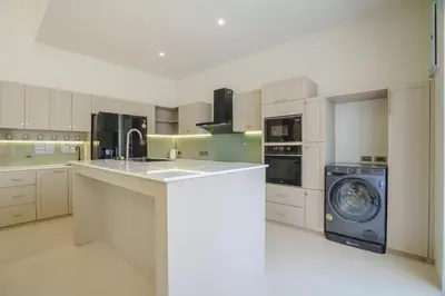 a kitchen with a washer and a washing machine at New Celine Villa Private Pool Near Beaches in Ban Saiyuan (1)