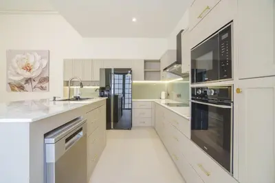 a kitchen with white counter tops and appliances at New Celine Villa Private Pool Near Beaches in Ban Saiyuan (1)