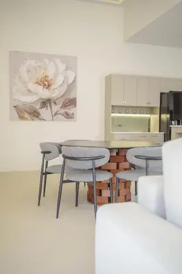 a kitchen with four chairs and a table with a flower painting at New Celine Villa Private Pool Near Beaches in Ban Saiyuan (1)