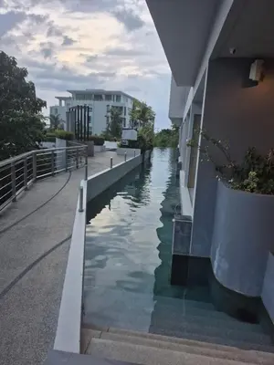 a canal of water next to a building at The Ark Condomisunset in Ban Karon