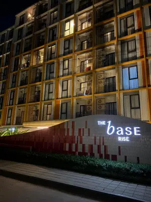 a large building with a sign in front of it at Rest&Rise Phuket in Ban Rangeng