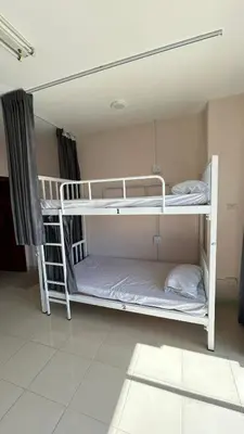 a room with two bunk beds in a room at rawai cozy hostel in Rawai Beach