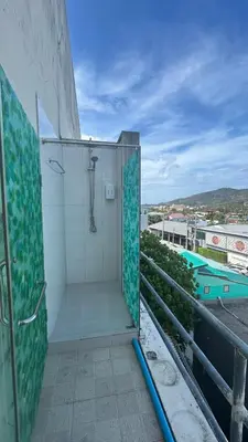 a bathroom with a shower on top of a building at rawai cozy hostel in Rawai Beach
