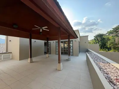 a porch of a house with a ceiling fan at Harmony 3 Bedrooms Private Pool Villa in Laguna Phuket