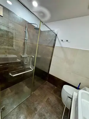 a bathroom with a shower and a toilet and a sink at One BR 24 in Ban Karon
