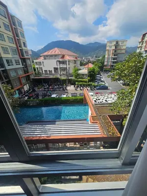 a view of a pool from a balcony of a building at Dcondo in Ban Kathu