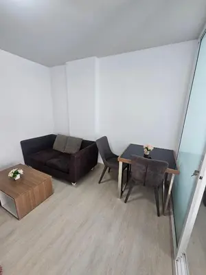a living room with a couch and a table at Dcondo in Ban Kathu